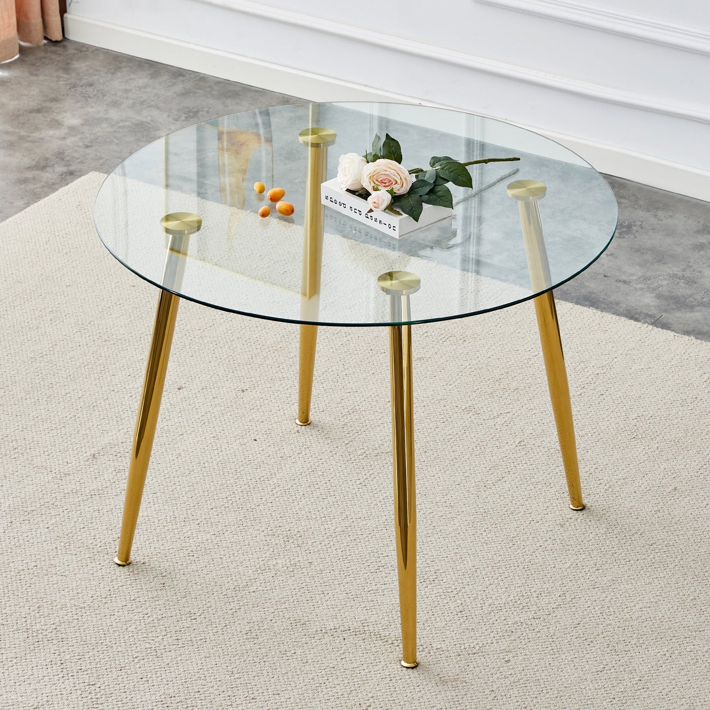 A Glass Tabletop With a Diameter of 40 Inches and a Modern Minimalist Circular Dining Table With Gold Plated Metal Legs.